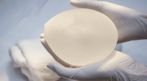 Textured implant in gloved hands